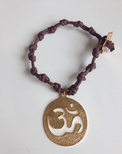 OM Gold plated charm with knotted cord