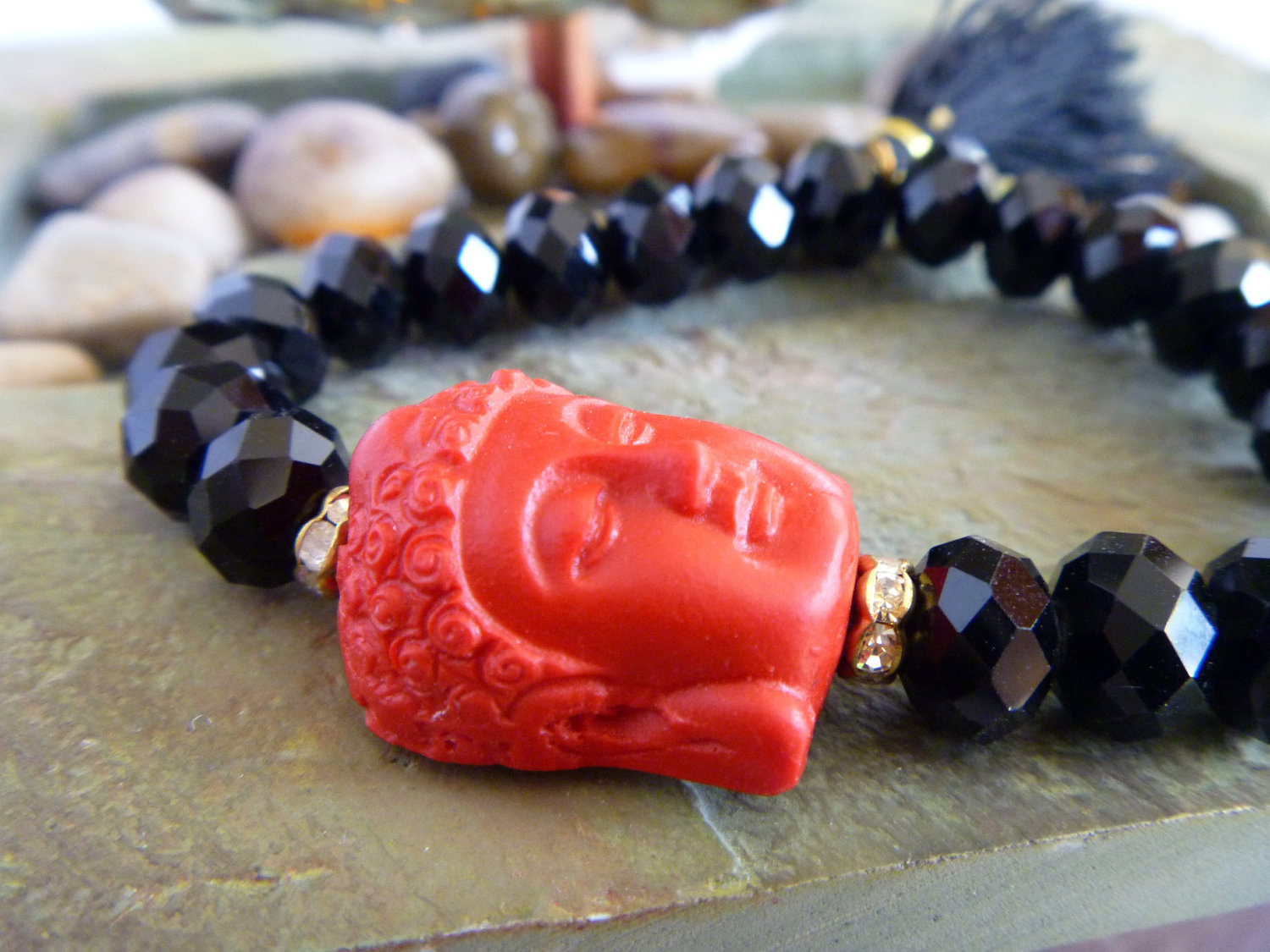 Red buddha head with Black tassol and black beads